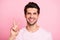 Closeup photo of amazing guy sending friends v-sign symbol wearing casual outfit isolated on pink background