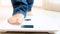 Closeup photo of barefoot person stepping on electronic scales