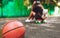 Closeup photo basketball ball with girl sitting on plastic orange penny