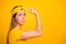 Closeup photo of beautiful lady trying hard to make hand muscle bigger wear casual t-shirt isolated yellow background