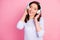 Closeup photo of beautiful lady wavy hairdo hold arms on cool modern technology headphones eyes closed enjoy youth music