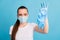 Closeup photo of beautiful negative lady hold dirty surgical latex gloves afraid infections disgusted expression wear