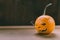 Closeup Photo of Carved Baby Pumpkin on the Wodden Background