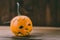 Closeup Photo of Carved Baby Pumpkin on the Wodden Background