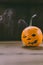 Closeup Photo of Carved Baby Pumpkin on the Wodden Background