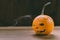 Closeup Photo of Carved Baby Pumpkin on the Wodden Background