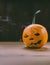 Closeup Photo of Carved Baby Pumpkin on the Wodden Background