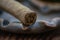 Closeup photo of a cigar on a clay ashtray