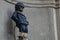 Closeup photo with dressed Manneken Pis, a little statue of boy urinating in Brussels, Belgium - landmark