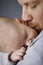 Closeup photo of father kissing newborn baby