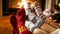 Closeup photo of female feet in warm woolen socks warming by the fireside at house