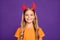 Closeup photo of funny little lady with long hair and headband playing helloween party satan devil character wear orange