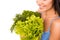 Closeup photo of a girl holding a bag full of greens and vegetables