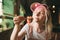 Closeup photo of girl holding chopsticks with sushi roll, lady with closed eyes enjoying delicious Japanese food. Attractive woman