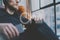 Closeup photo handsome bearded man headphones listening to music modern loft studio.Man sitting in vintage chair,holding smartphon