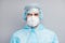 Closeup photo of handsome guy expert doc virology center clinic wear respiratory mask hazmat blue uniform suit plastic