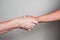 Closeup photo of interracial handshake, hand with vitiligo spots. Concept of care and protection