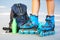 Closeup photo of legs in blue inline skates standing.