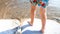 Closeup photo of little childs feet walking on the wet sand at sea beach