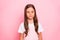 Closeup photo of little cute lady brown hair holidays mood calm wear rose overall white t-shirt isolated pink background