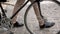 Closeup photo of male feet next to vintage bicycle on paved road