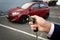 Closeup photo of man opening car with remote alarm key