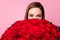 Closeup photo of pretty charming lady enjoy large one hundred roses bouquet hiding half face shy look isolated pastel