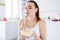 Closeup photo of pretty housewife lady sit morning kitchen have breakfast eat cereal corn flakes milk lick spoon stay