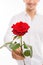 Closeup photo of a romantic handsome man with a red rose