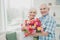 Closeup photo of two adorable aged people cute pair anniversary holiday surprise big red tulips bunch flat indoors