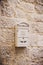 Closeup photo of a Vintage postbox on old stone wall