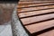 Closeup photo of wet bench on the Griboyedov channel embankment in Saint Petersburg on a rainy autumn day in October. Wet wooden