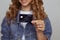 Closeup photo of woman with black credit card isolated.