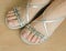 Closeup photo of woman feet in beautiful evening sandals modeling