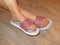 Closeup photo of woman feet in slipper on hardwood floor