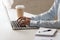 Closeup photo of woman hands typing on notebook at desktop