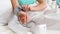 Closeup photo of woman putting on sleeve of digital blood pressure manometer