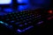 Closeup photo of workplace with led rainbow backlight gaming key