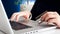 Closeup photo of young woman working on laptop typing number of her credit card