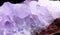 Closeup photograph of translucent amethyst stone on red