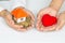 Closeup picture of female hands holding model house and red heart. charity, real estate and family home concept