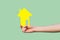 Closeup picture of hands showing, holding yellow small paper house, mortgage concept, new future house, safety symbol