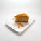 Closeup of a piece of pumpkin pie on a plate isolated on a white background