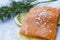 Closeup of piece of salmon,dill,seasalt,slices of lemon on blue table