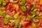 Closeup of pieces of jalapeno peppers on spicy pepperoni pizza