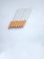 Closeup of a pile of cigarettes over white background. The tobacco can cause numerous damages to the organism