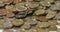 Closeup of pile of Money. Euro coins One and Two coins, surrounded by lower denomination Coins. Gold and Bronze