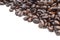 closeup piled of coffee beans group roast dark brown colour textured isolated on white backgrounds