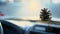 Closeup of pinecone hanging from car rear view mirror