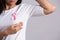 Closeup of pink badge ribbon on woman chest to support breast cancer cause. Healthcare, medicine and breast cancer awareness